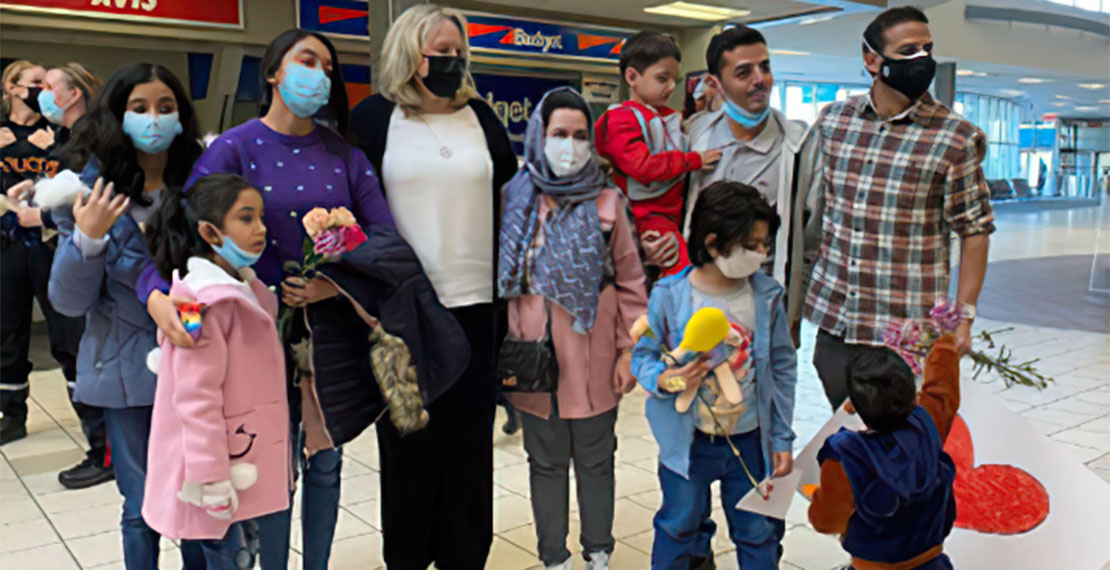 Selendy & Gay co-managing partner and Thirty Birds co-founder Jennifer Selendy (fourth from left) and Thirty Birds co-founder Justin Hefter (far right) with the Behroozian family, after safely landing in Saskatoon, Canada. Courtesy photo.